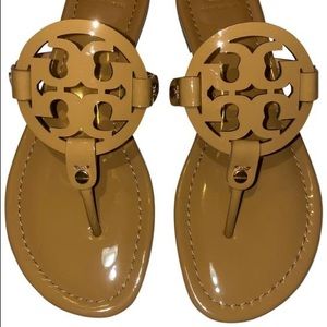Brown Tory Burch patent leather sandal.